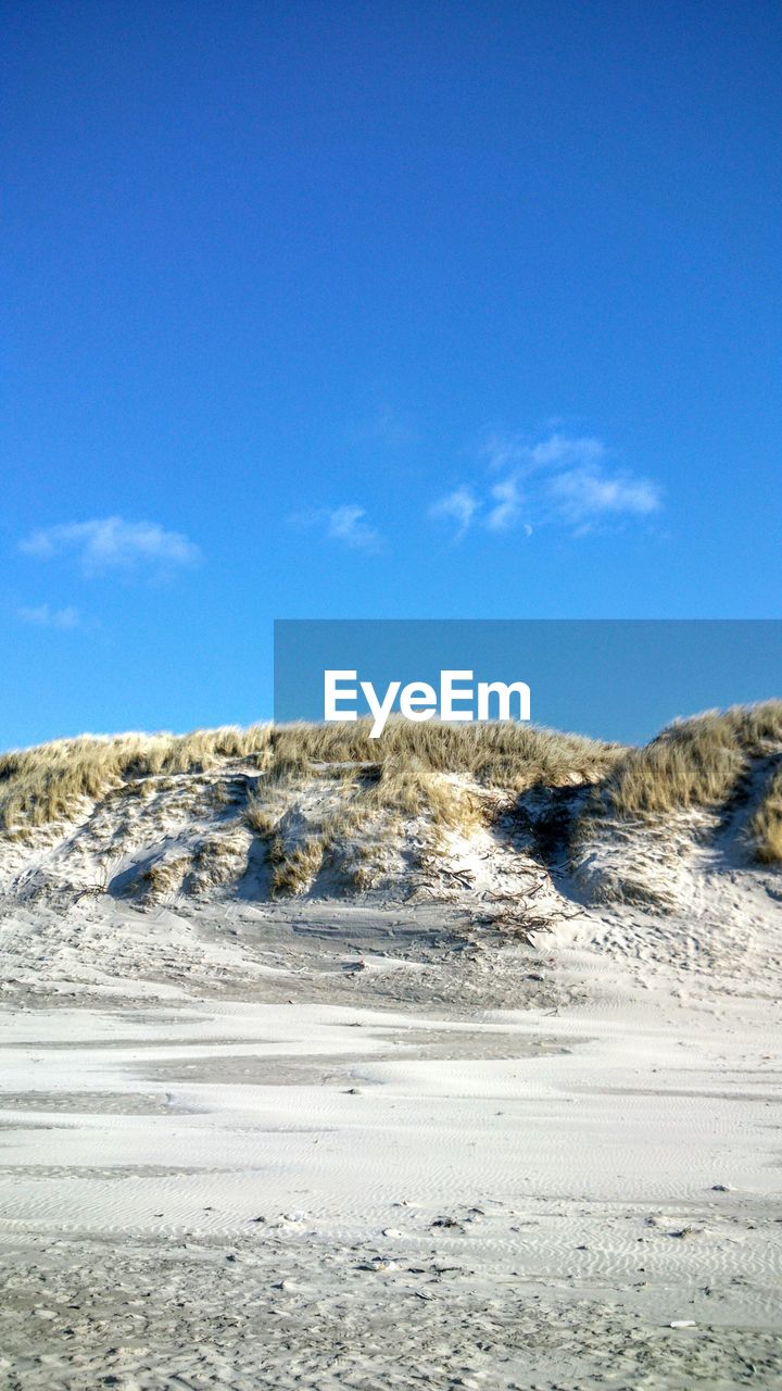 Scenic view of landscape against blue sky