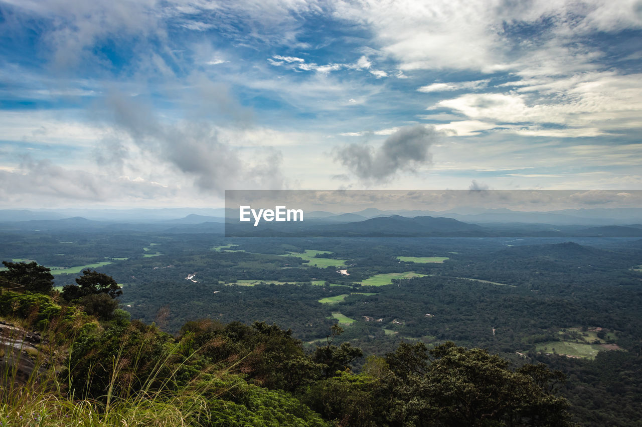 Mountain horizon coverd with cloud layers and forests