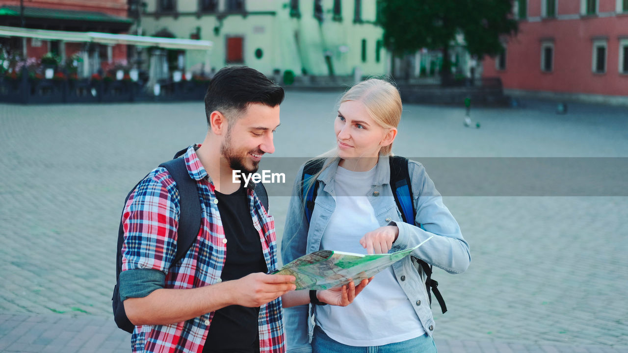 portrait of young woman using mobile phone in city