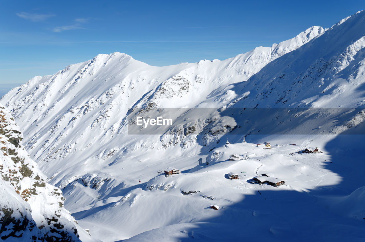 Scenic view of snow covered mountains against sky