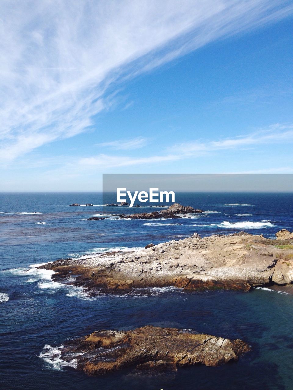 Scenic view of rocks in sea against sky