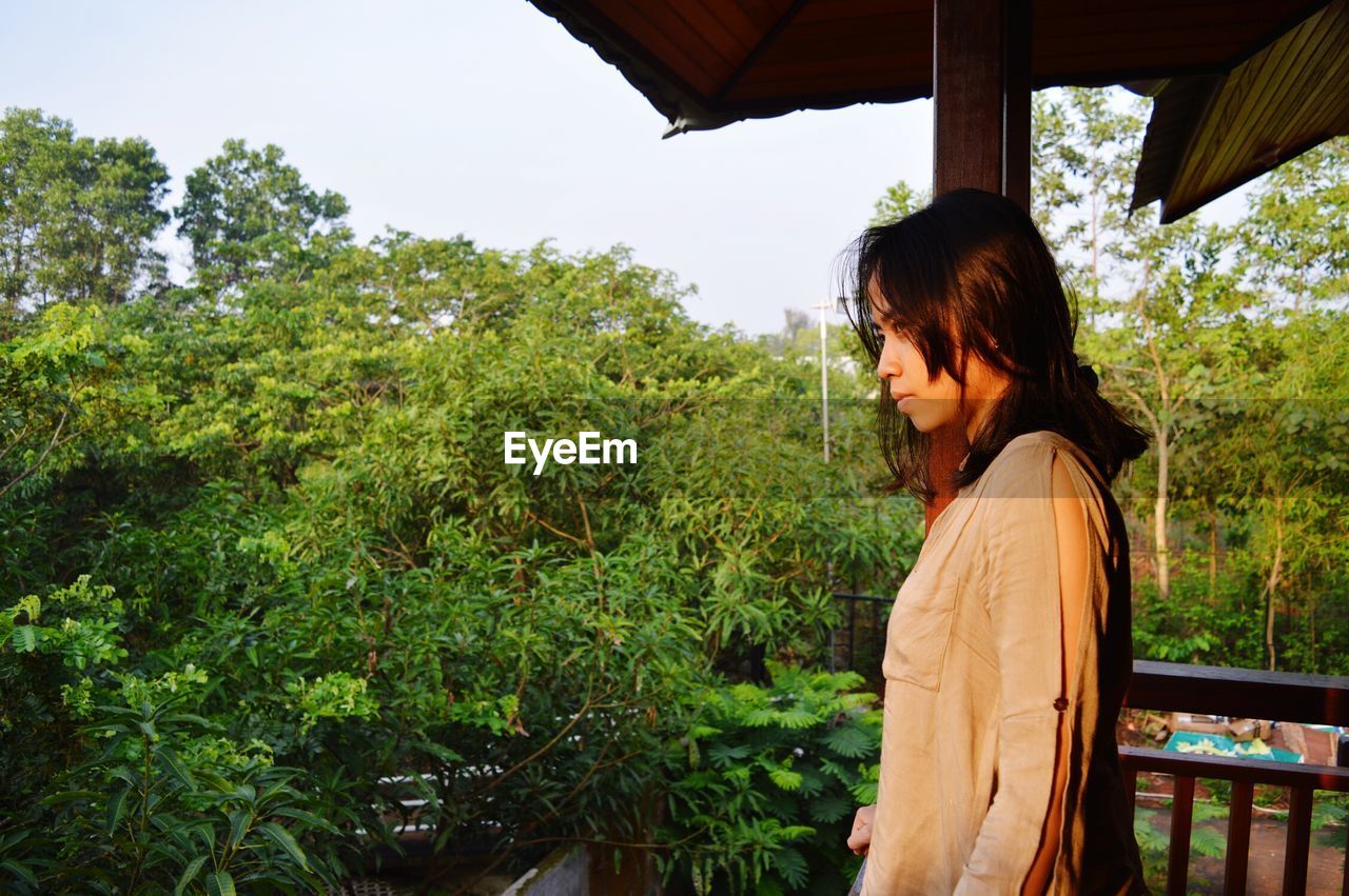 Side view of woman standing in balcony