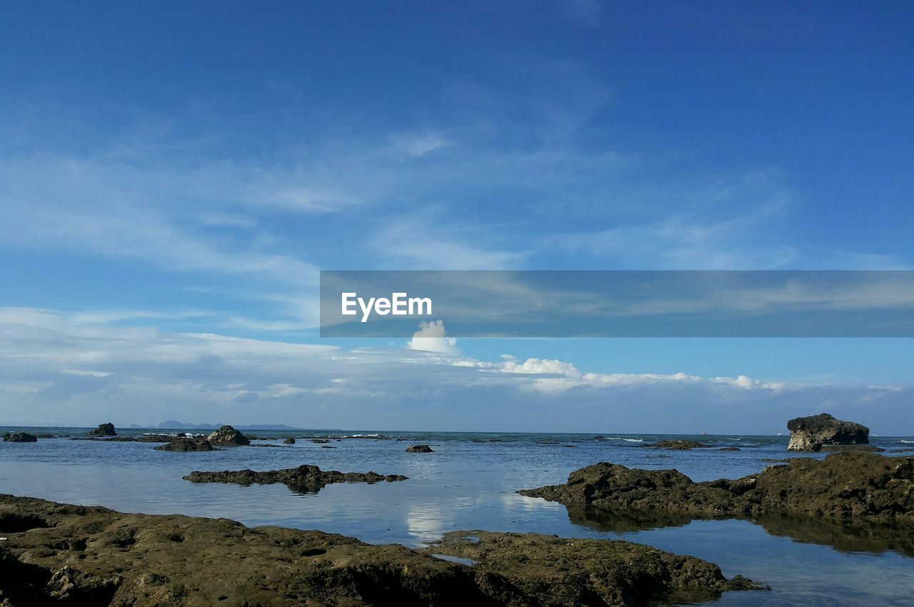 Scenic view of sea against cloudy sky