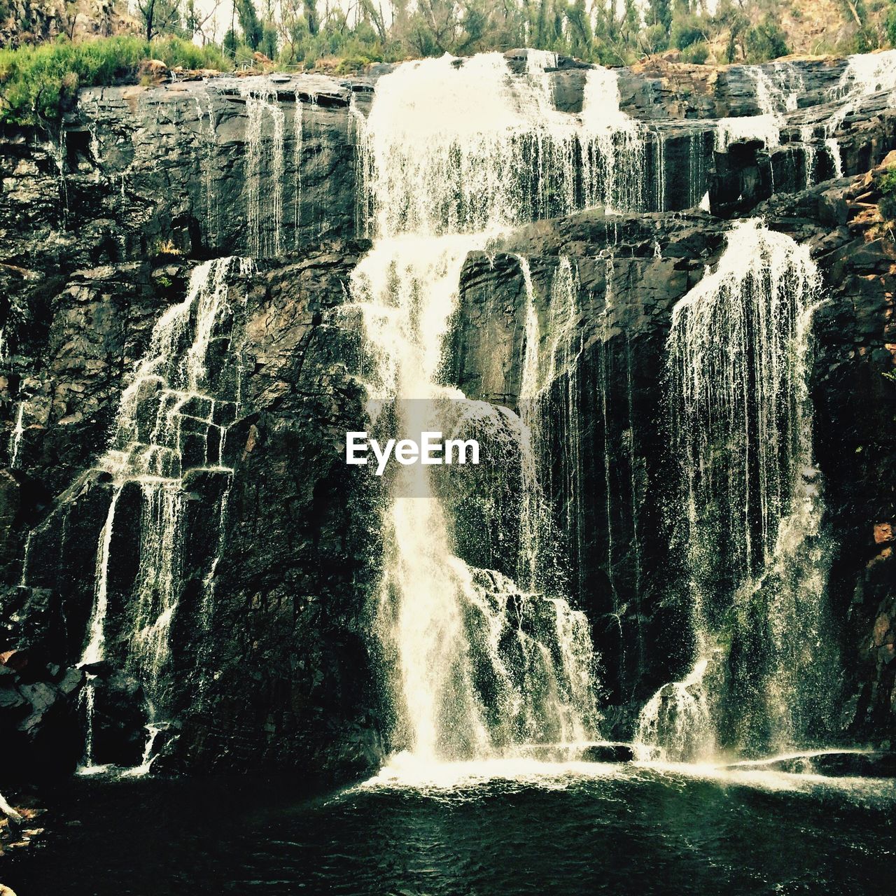 VIEW OF WATERFALL THROUGH ROCKS