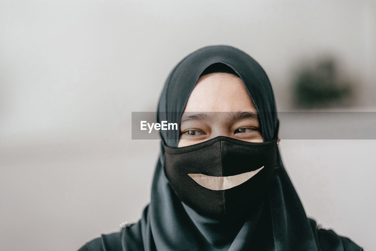 Close-up of young woman covering face