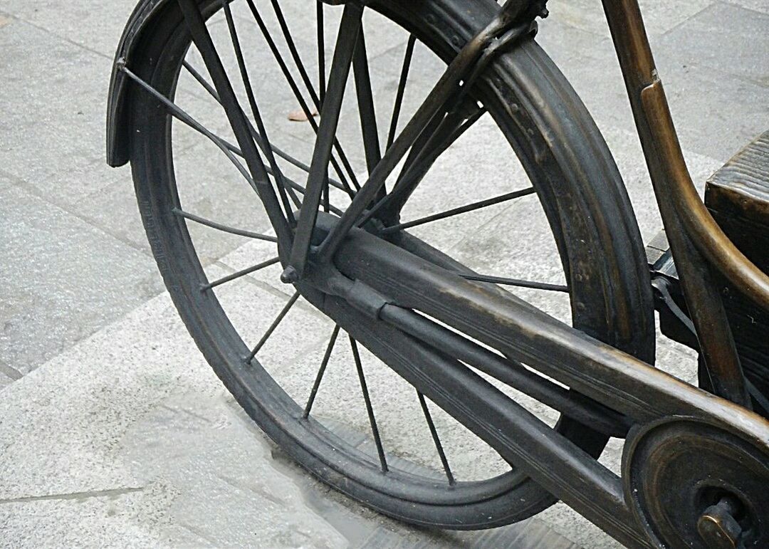 CLOSE-UP OF BICYCLE WHEEL AGAINST THE SKY