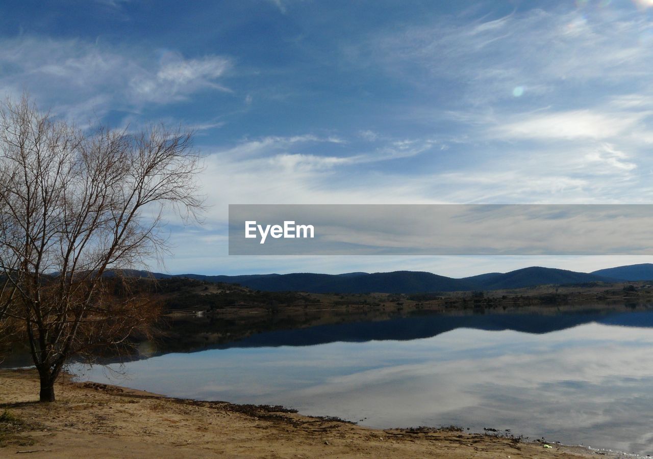 Scenic view of lake against cloudy sky