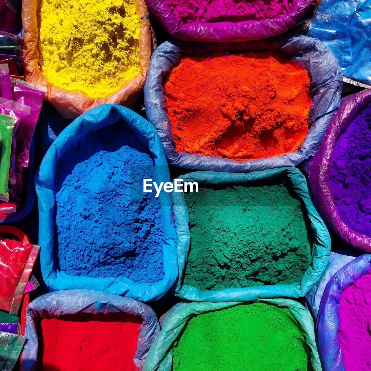 Multi colored powder paint for sale at market stall