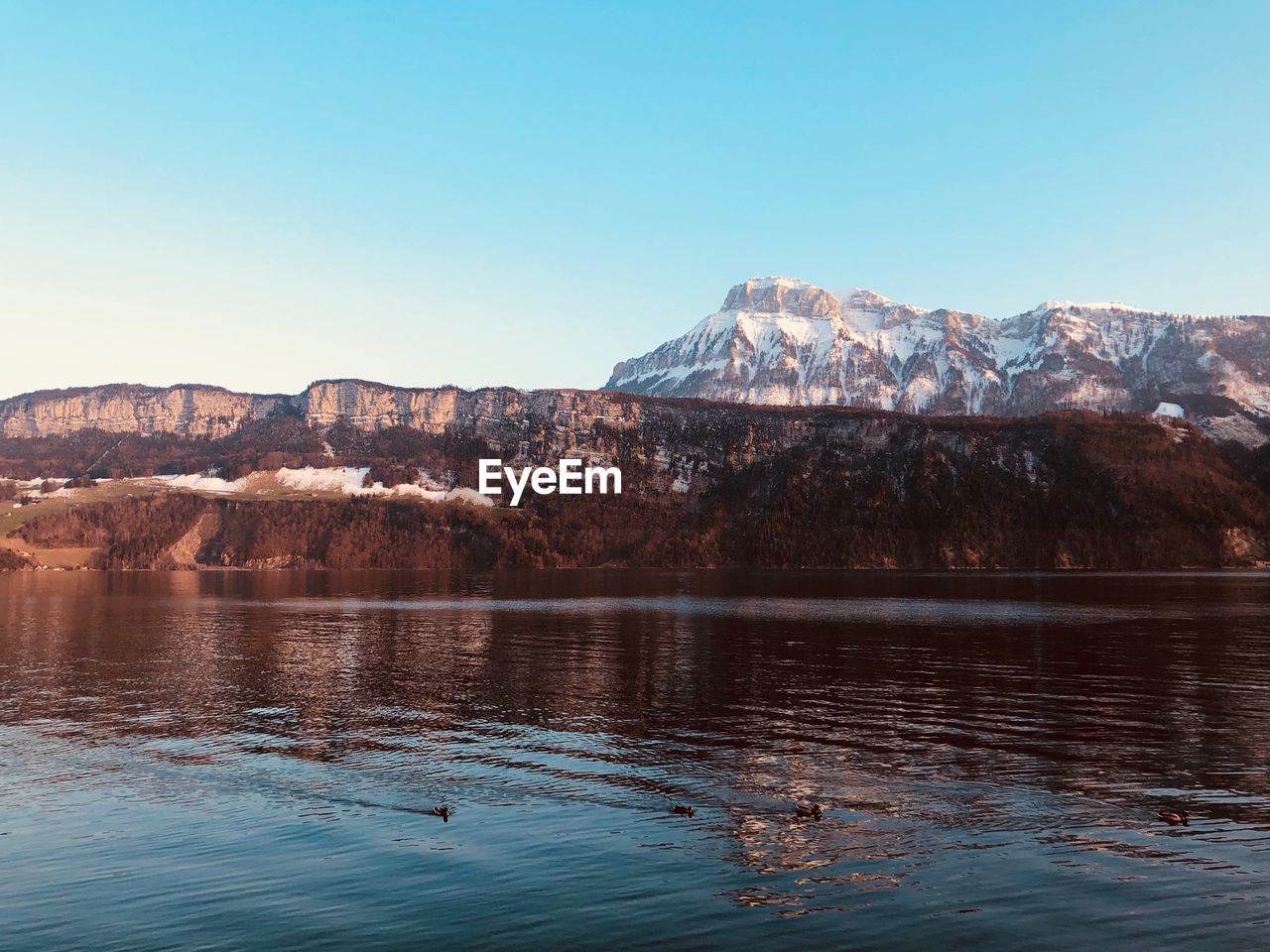 Scenic view of lake with mountain range in background