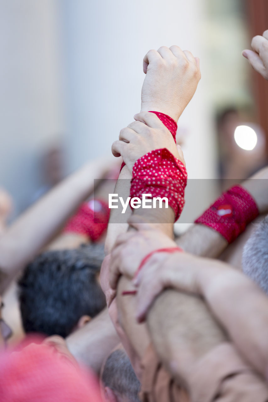 Close-up of hands with wristbands