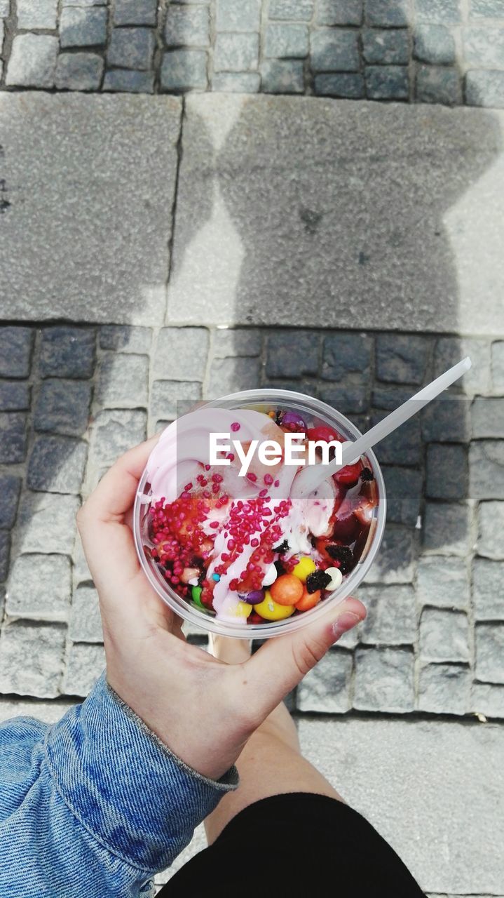 High angle view of woman holding ice cream