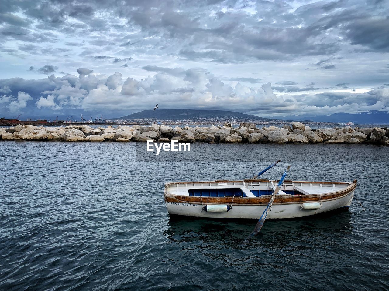 Boat moored on sea against sky