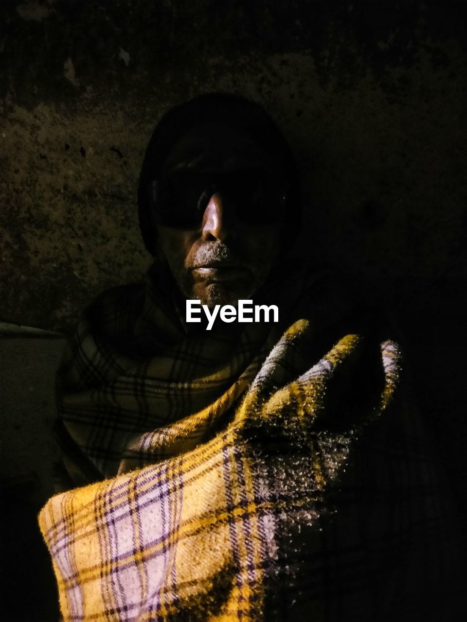 Mature man covered with shawl
