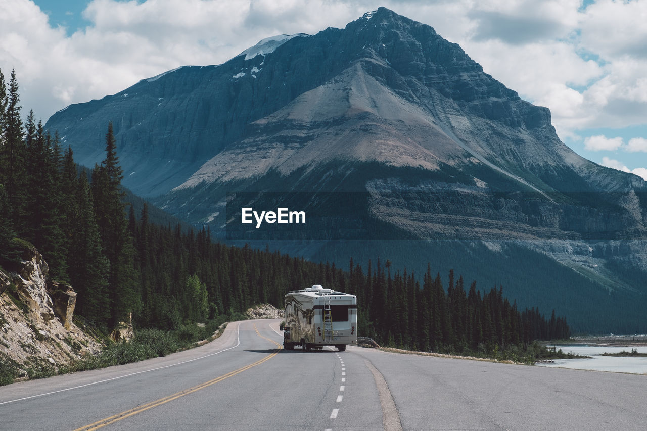 Vehicle on road against mountain