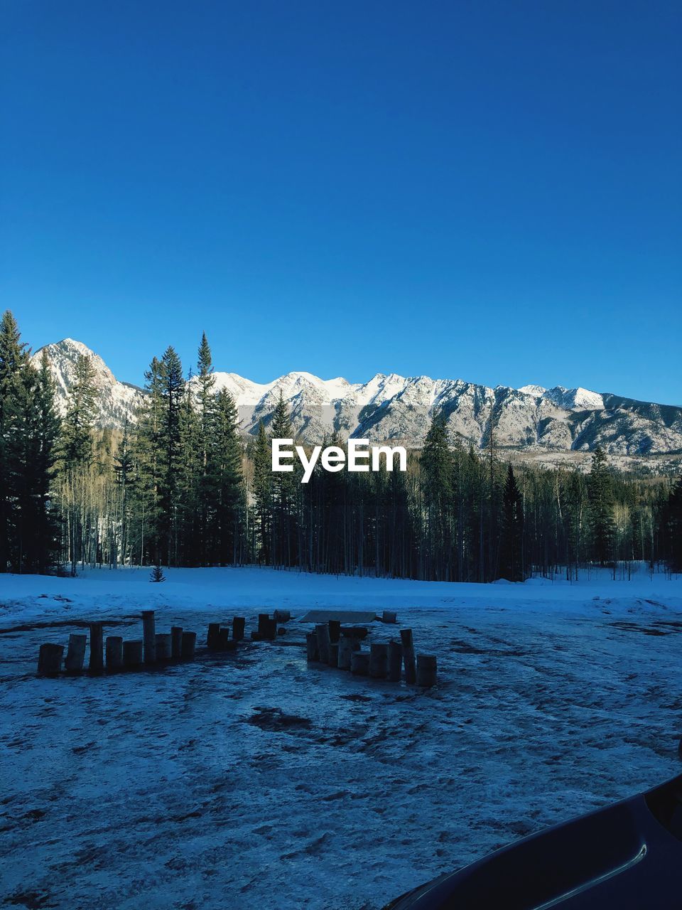 Scenic view of snowcapped mountains against clear blue sky