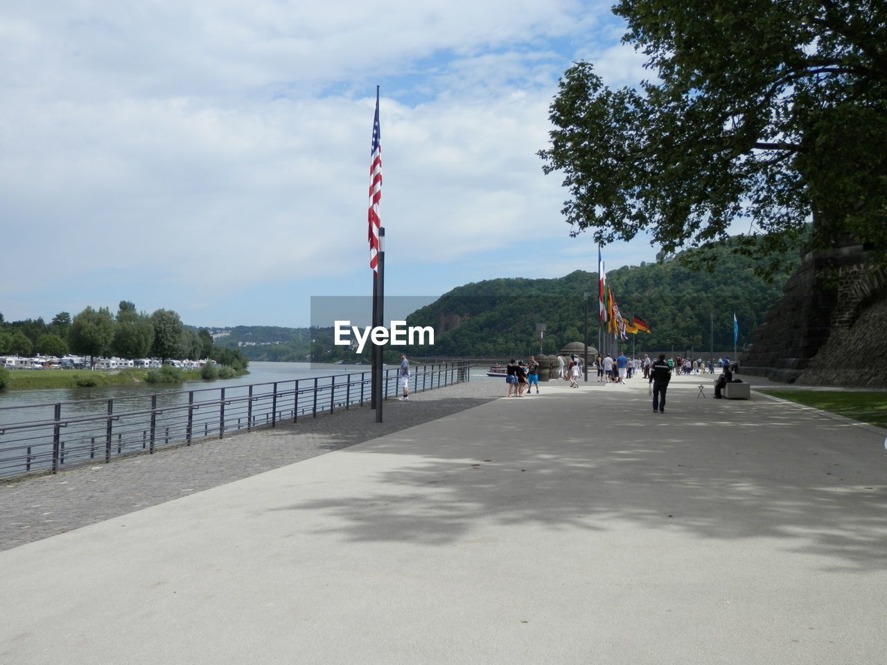 PEOPLE WALKING ON PIER OVER LAKE