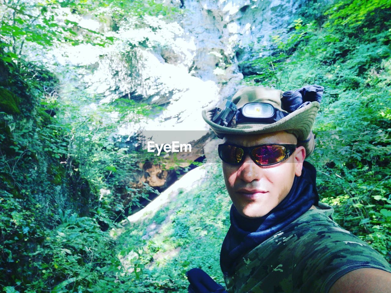 Portrait of man wearing sunglasses in forest