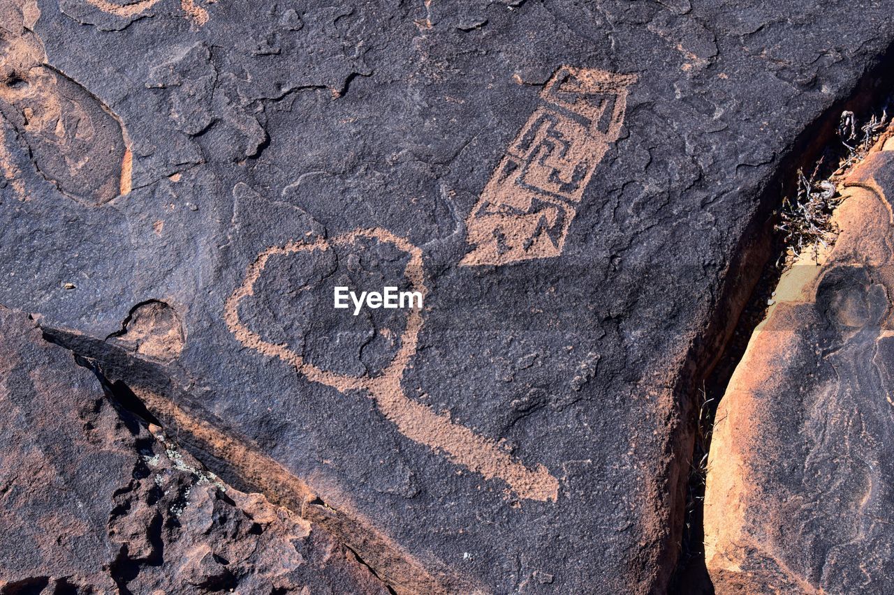 rock, soil, no people, geology, day, nature, text, wall, outdoors, wood, close-up, textured, creativity, communication, representation, history, full frame, craft, land, animal representation