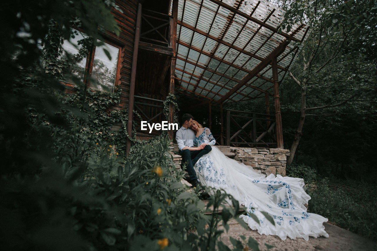 Full length of couple standing at cottage