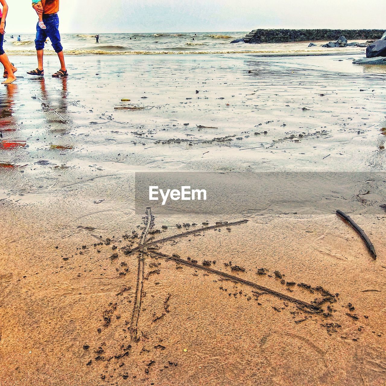 LOW SECTION OF WOMAN ON BEACH