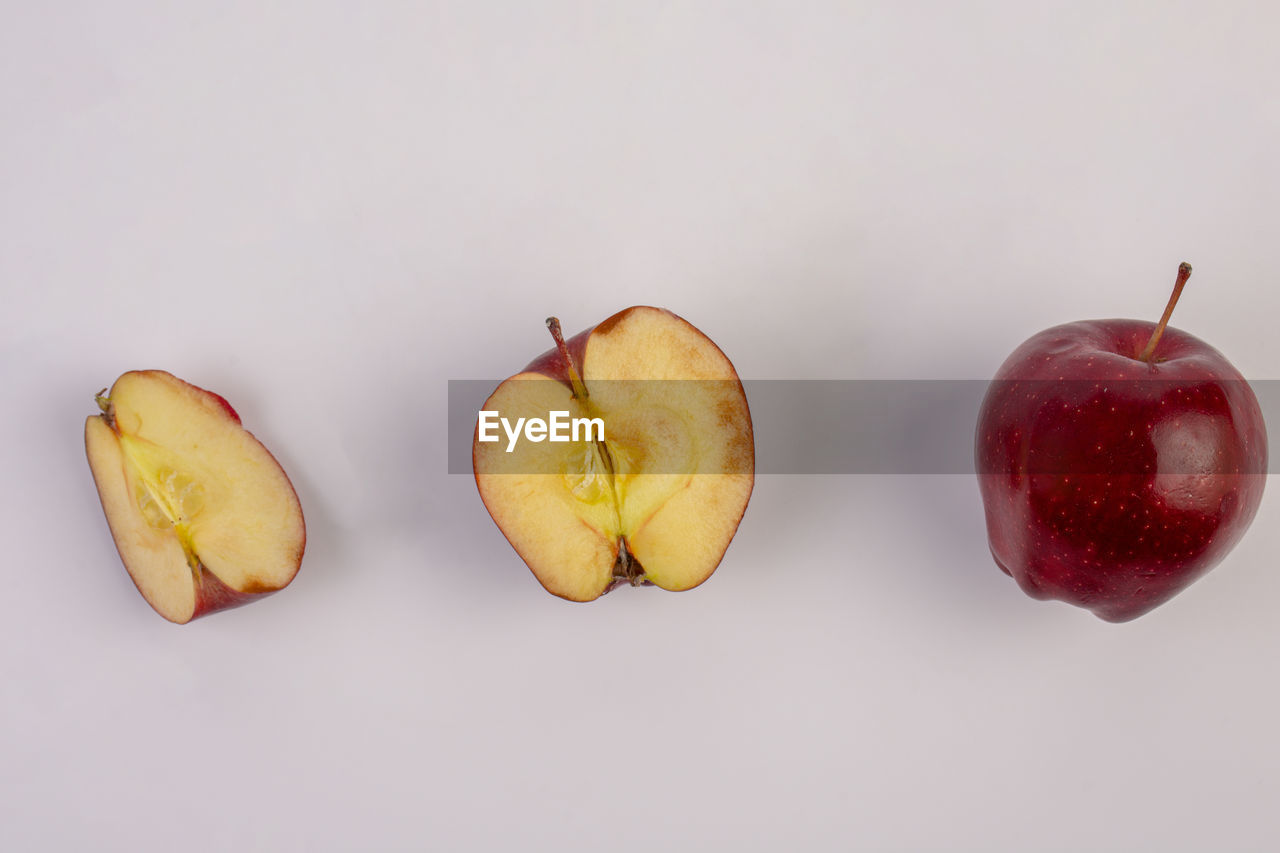 food and drink, food, healthy eating, fruit, plant, wellbeing, freshness, studio shot, produce, indoors, apple, apple - fruit, no people, still life, red, group of objects, close-up, cut out, petal, cross section, slice, white background, three objects
