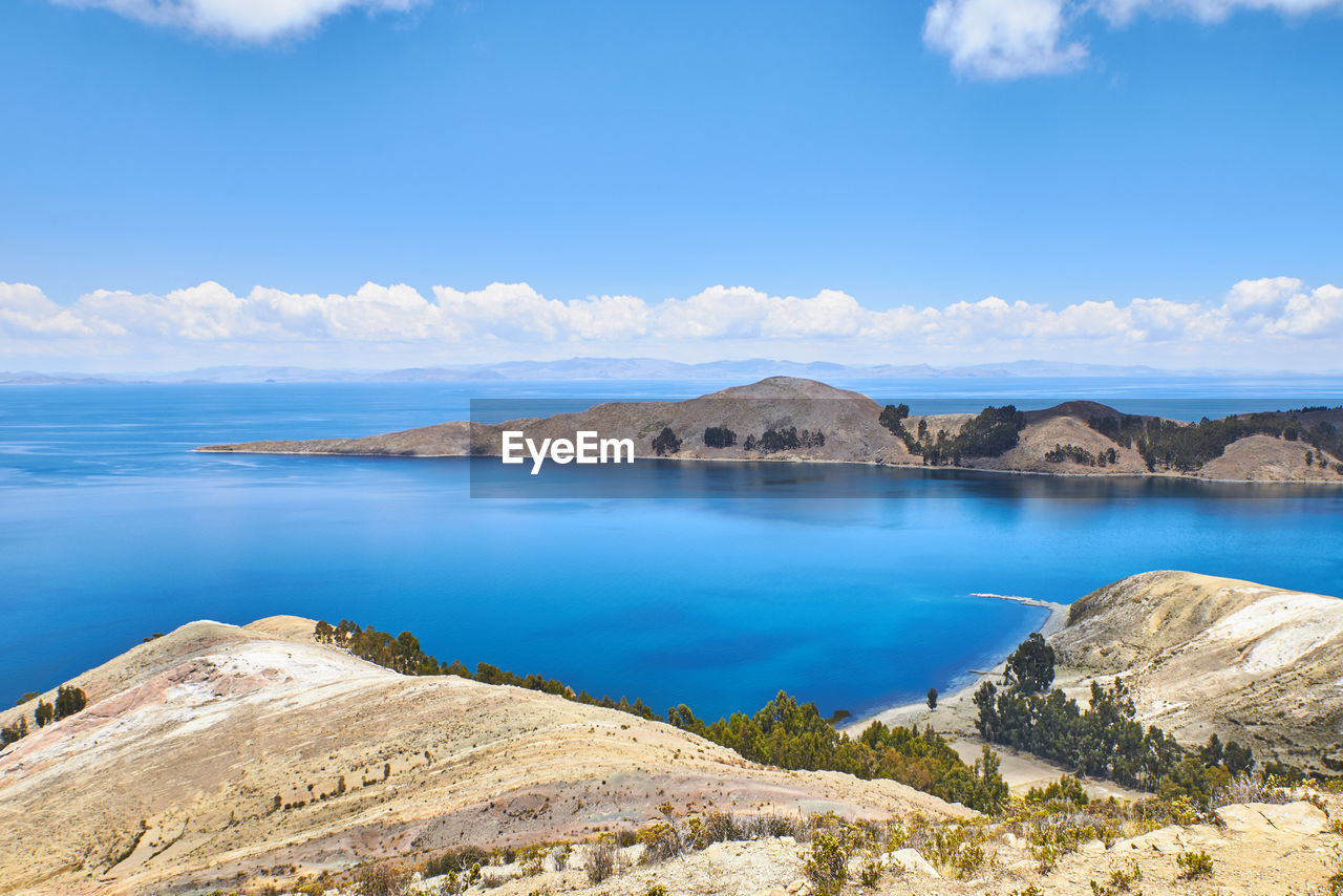 Scenic view of lake against blue sky