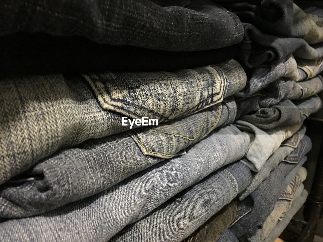 Close-up of stacked jeans