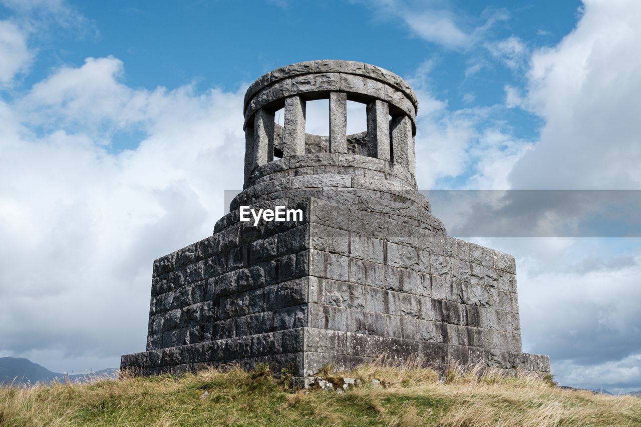 Low angle view of old monument against sky