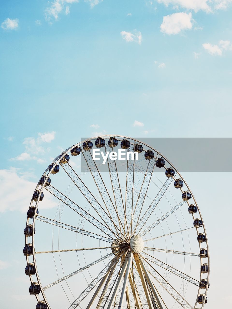 Low angle view of ferris wheel against sky