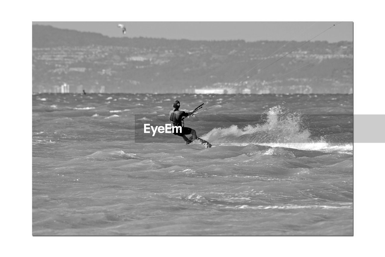 MAN SURFING ON SEA