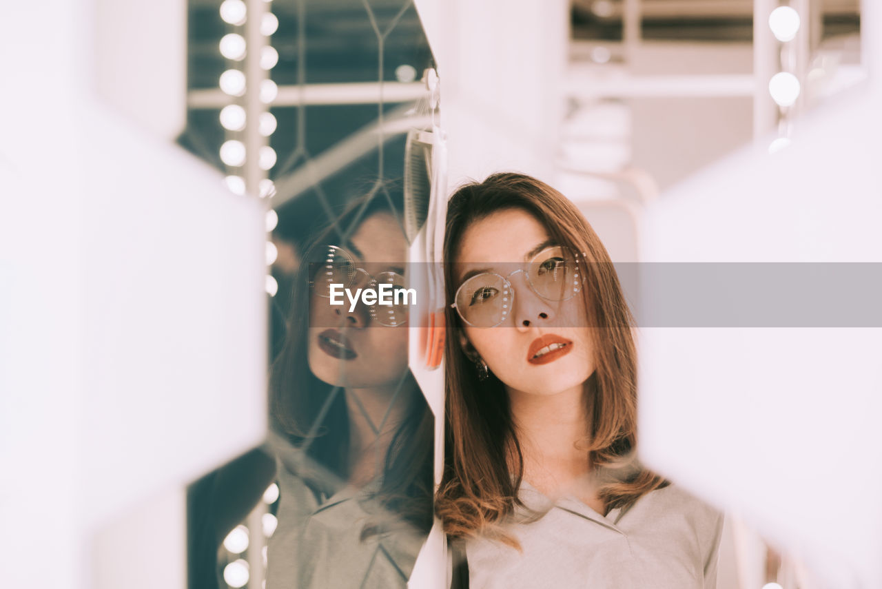 Portrait of mid adult woman reflecting on mirror