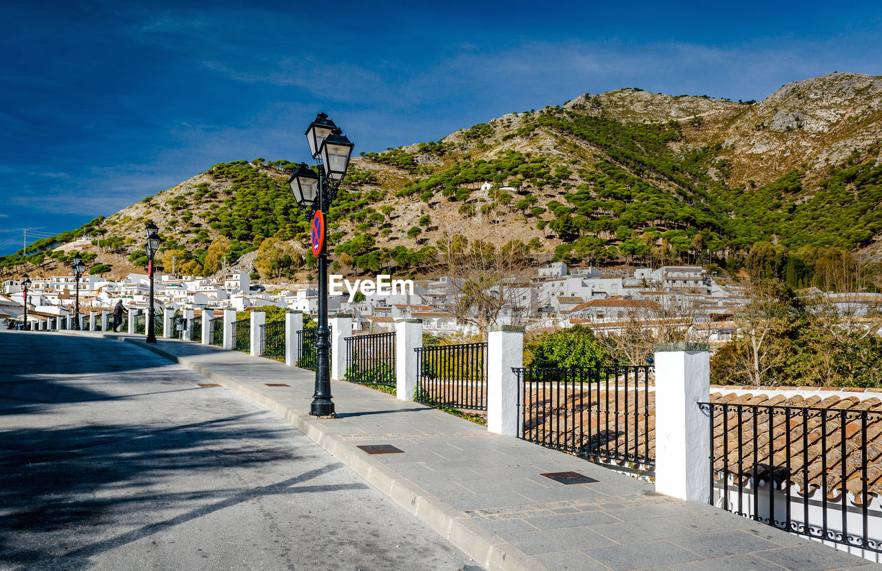 Road against mountain in town