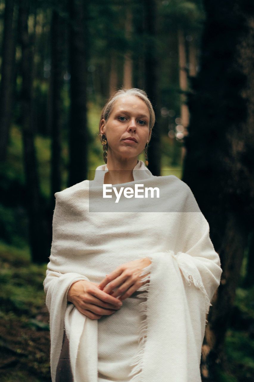 Portrait of woman standing in forest