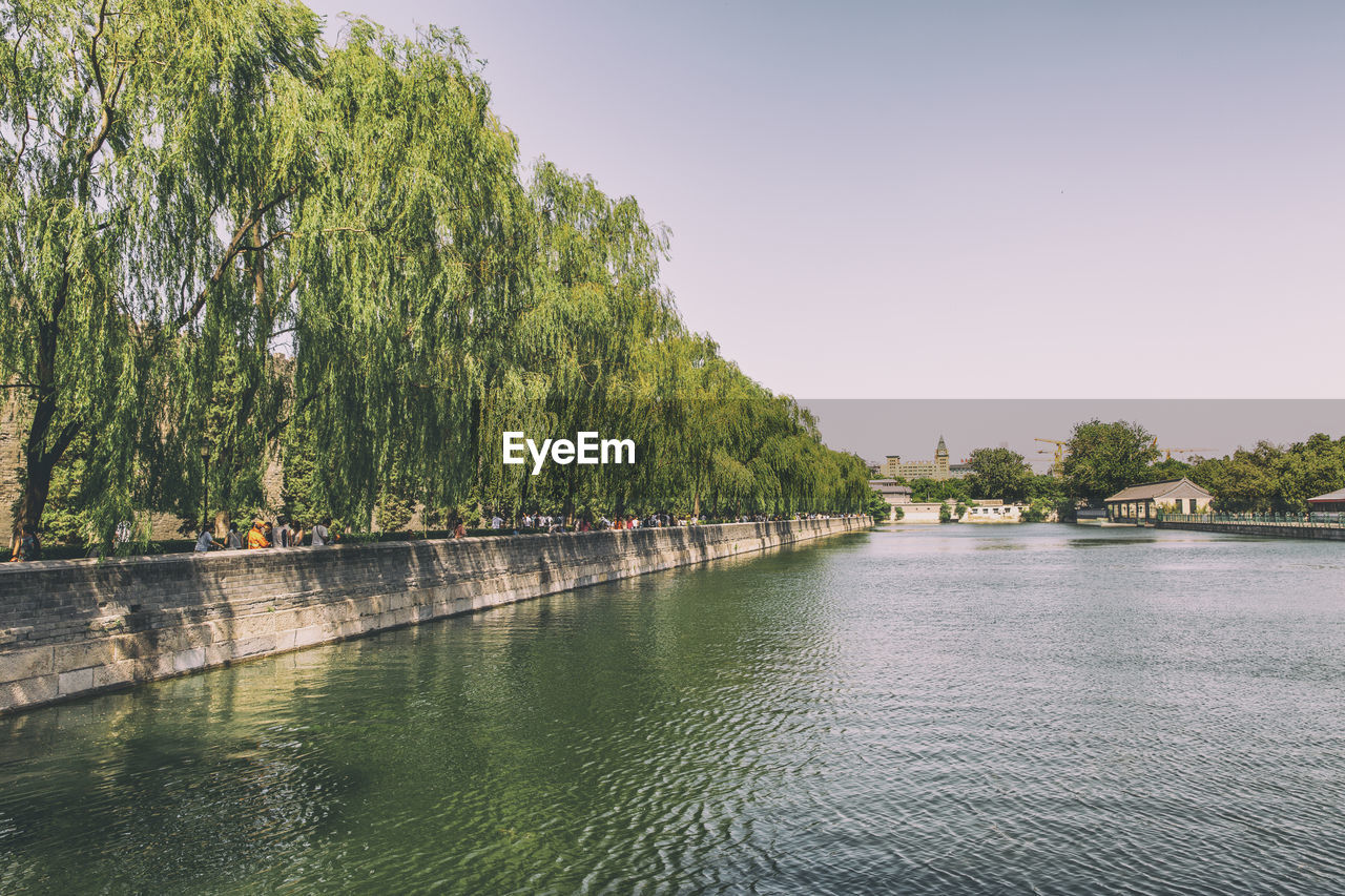 Scenic view of river surrounding forbidden city against clear sky