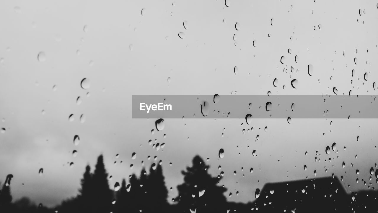 VIEW OF RAINDROPS ON GLASS WINDOW