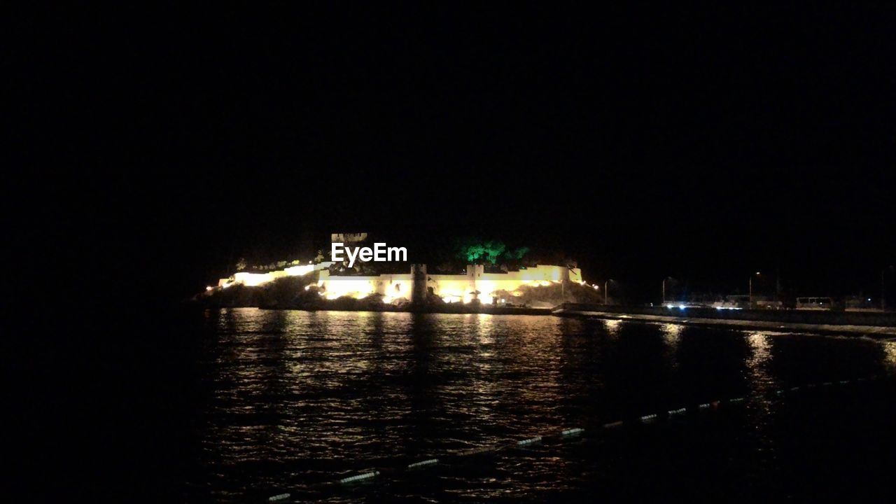 VIEW OF ILLUMINATED BUILDINGS AT NIGHT