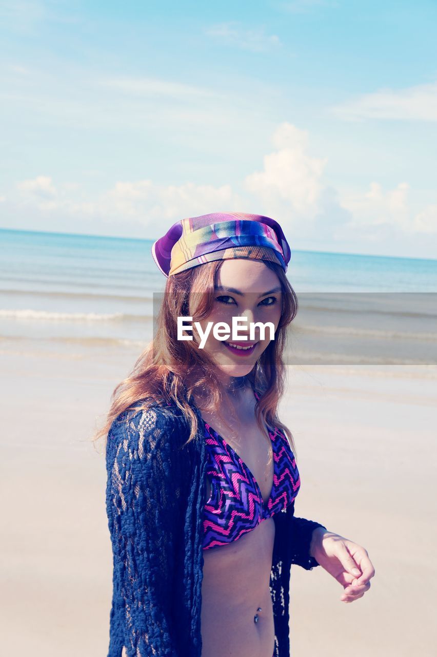 Portrait of beautiful young woman on shore of beach