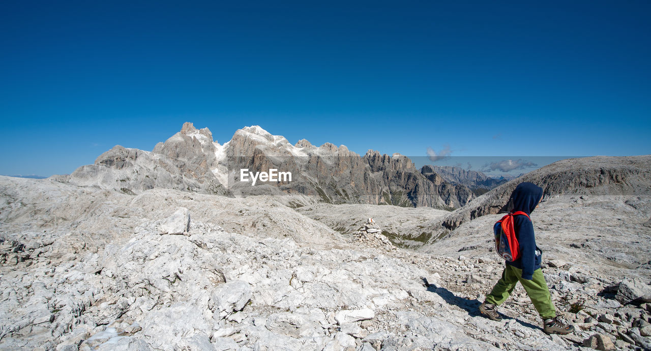 A boy walking in the nature of dolomites