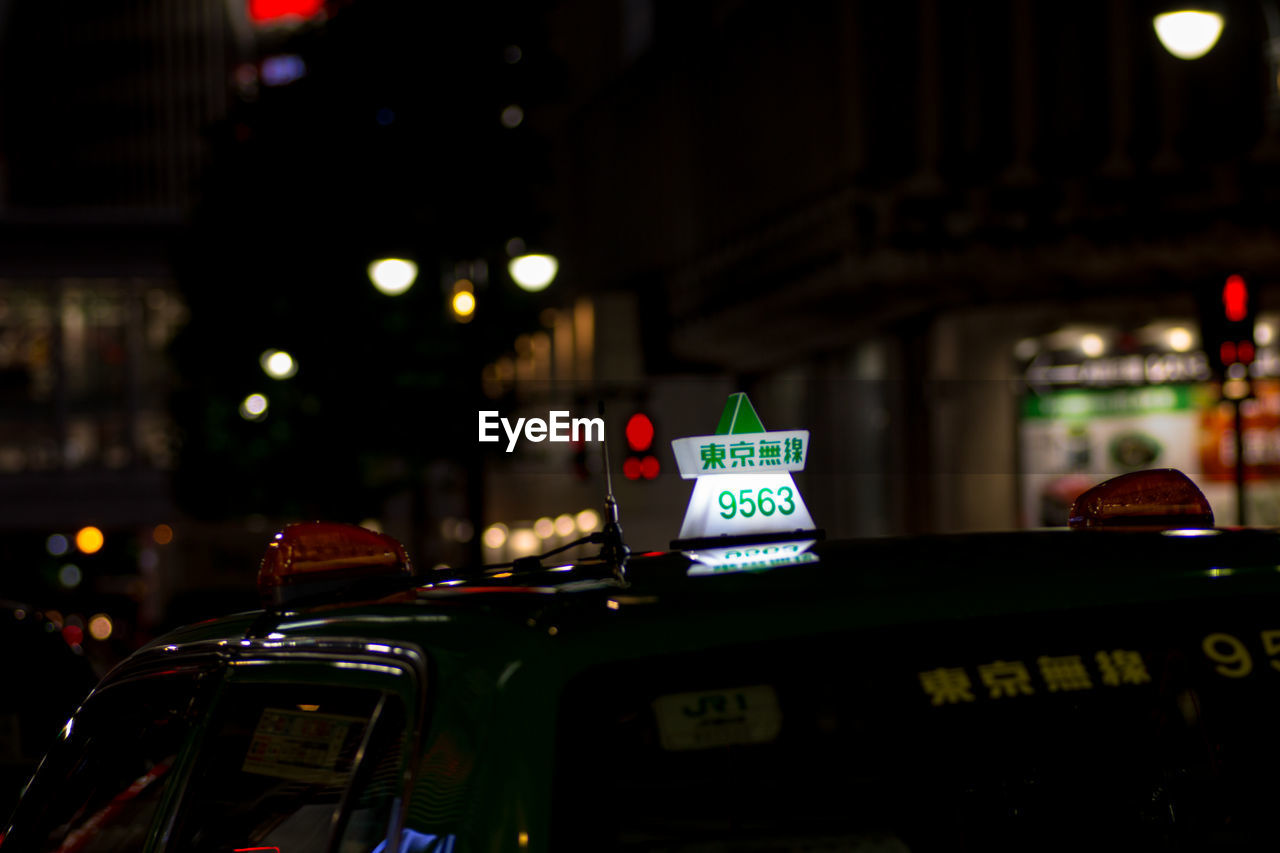 Illuminated information sign on taxi at night