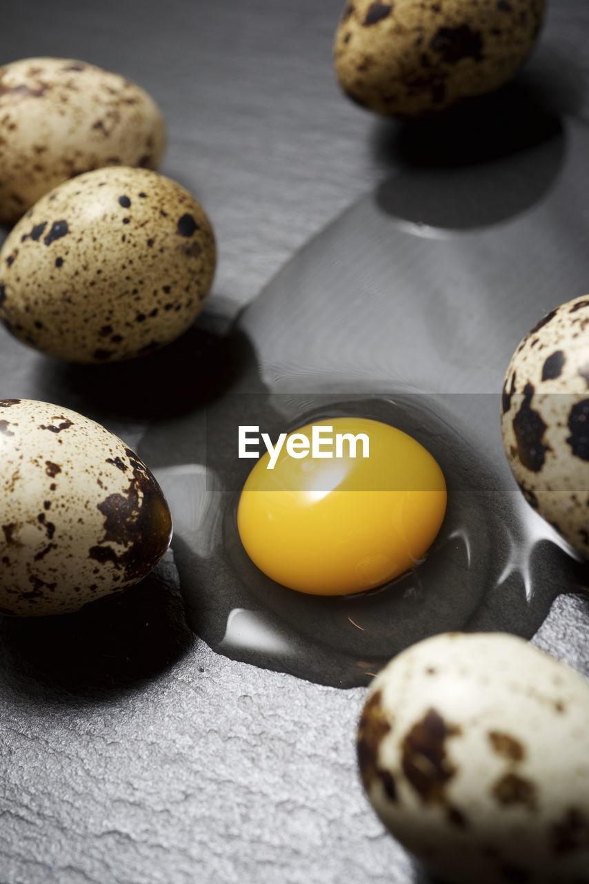 Quail eggs on a black table.