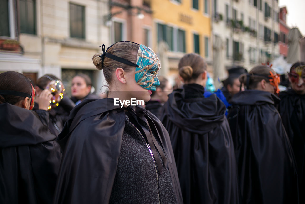 Women wearing mask against buildings8