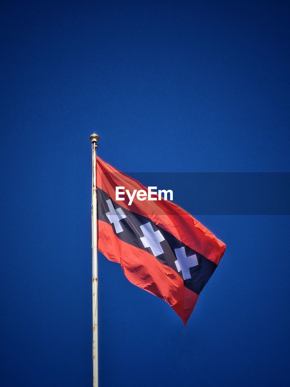 flag, blue, patriotism, red, sky, nature, wind, no people, environment, clear sky, low angle view, pole, day, symbol, copy space, outdoors, sunny