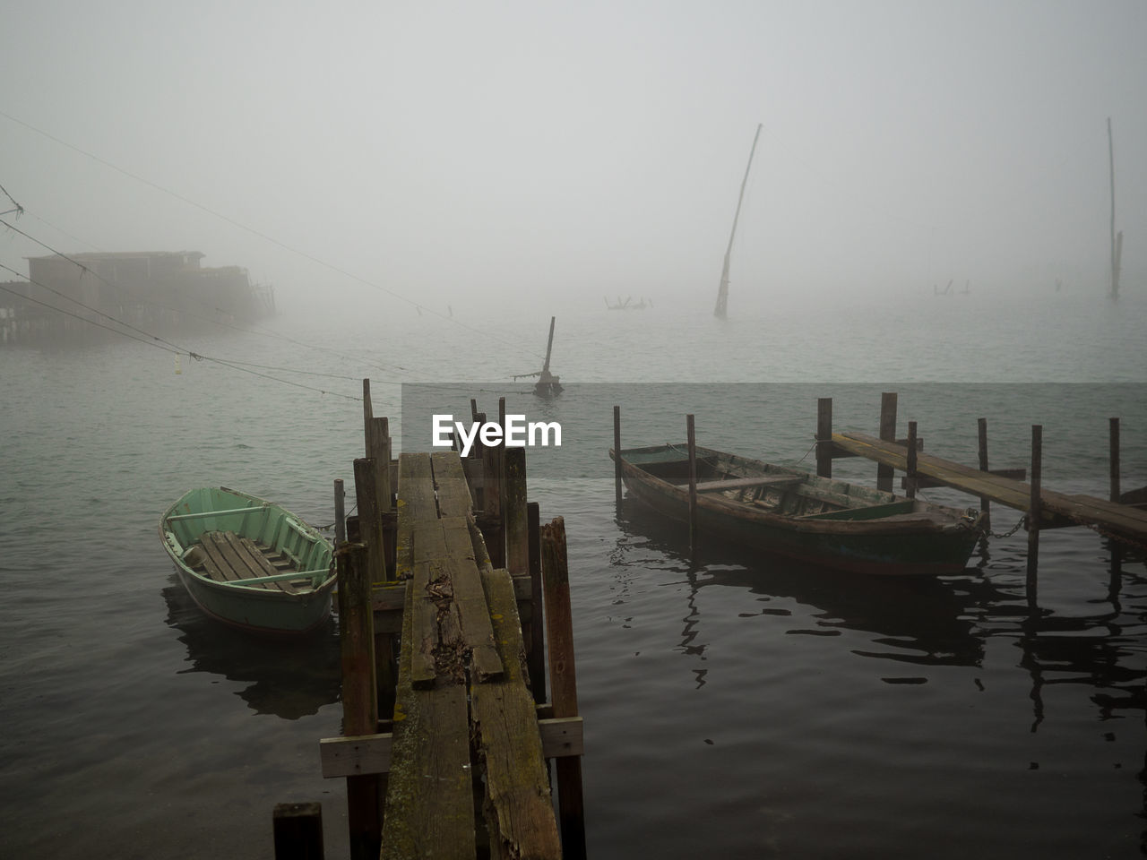 BOATS MOORED ON SEA AGAINST SKY