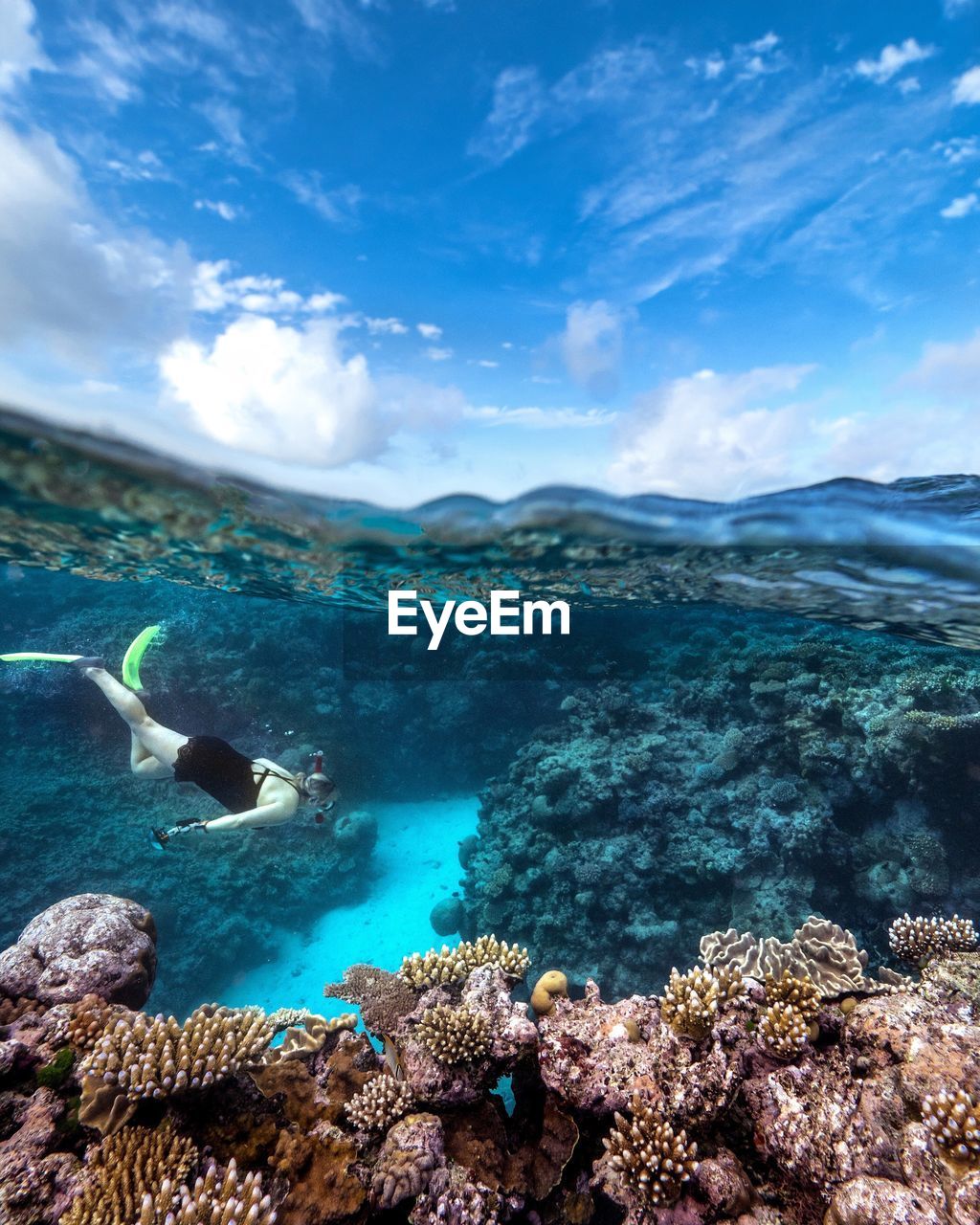 SCENIC VIEW OF SEA AND CORAL AGAINST SKY