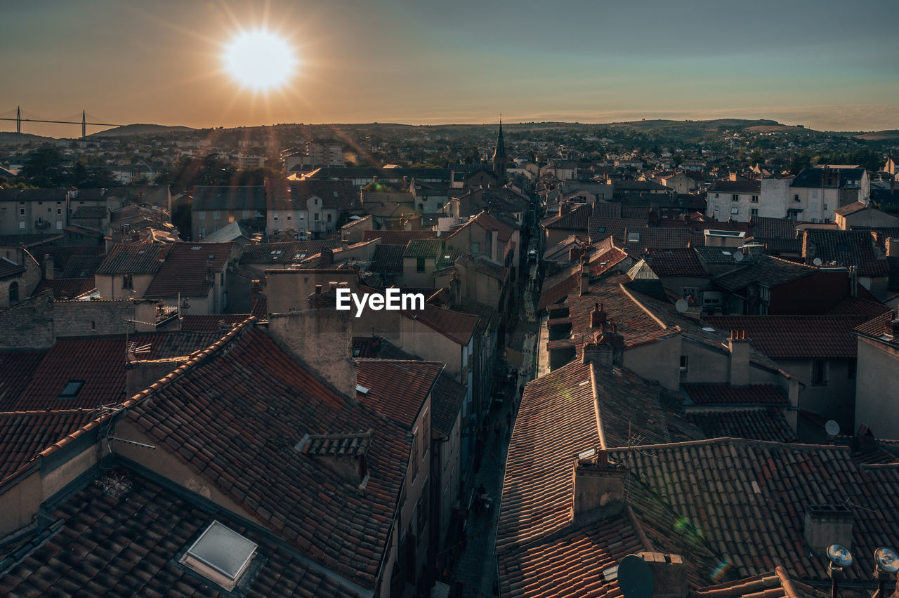 Aerial view of townscape against sky at sunset