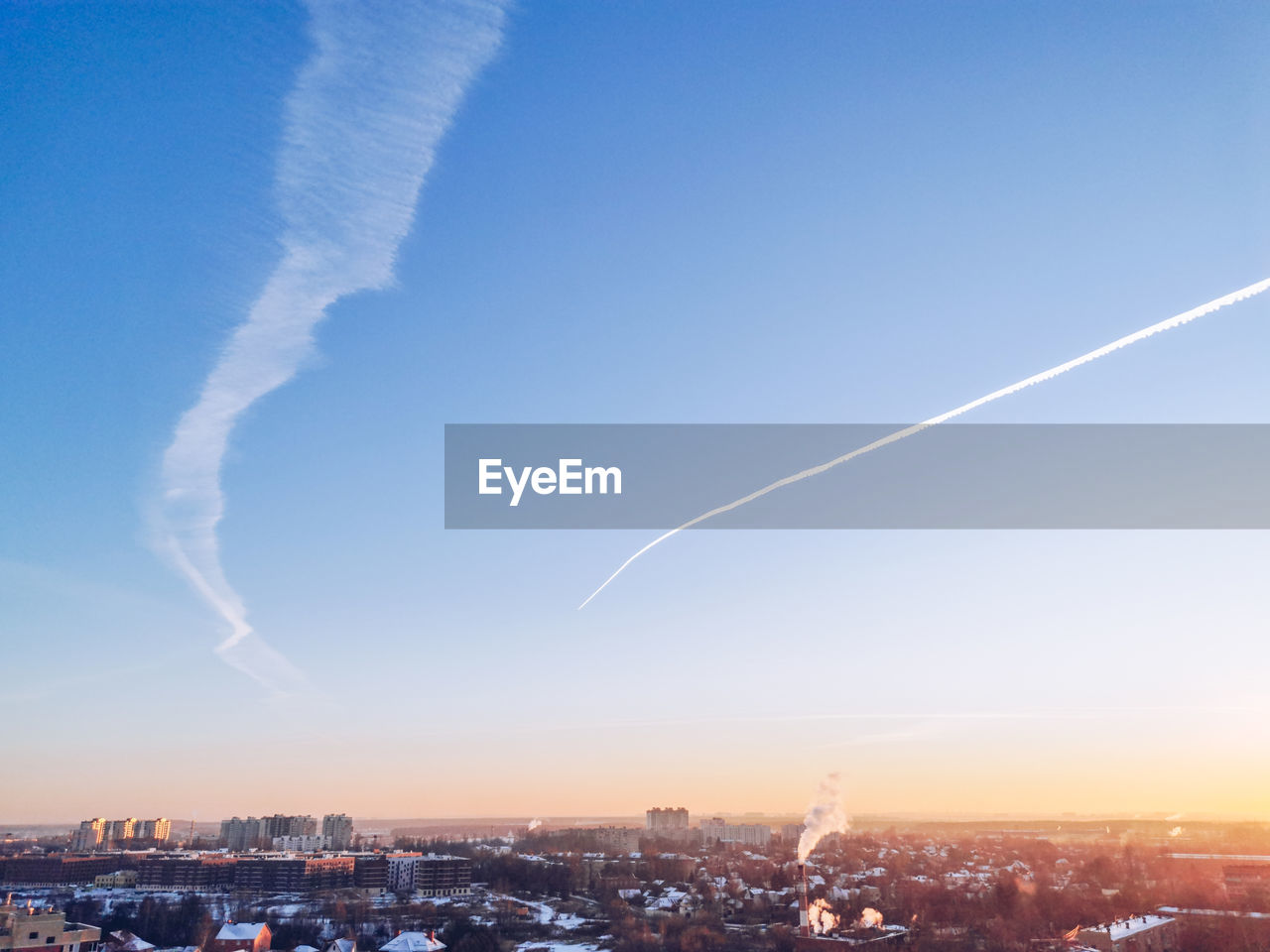 Aerial view of city against sky at sunset