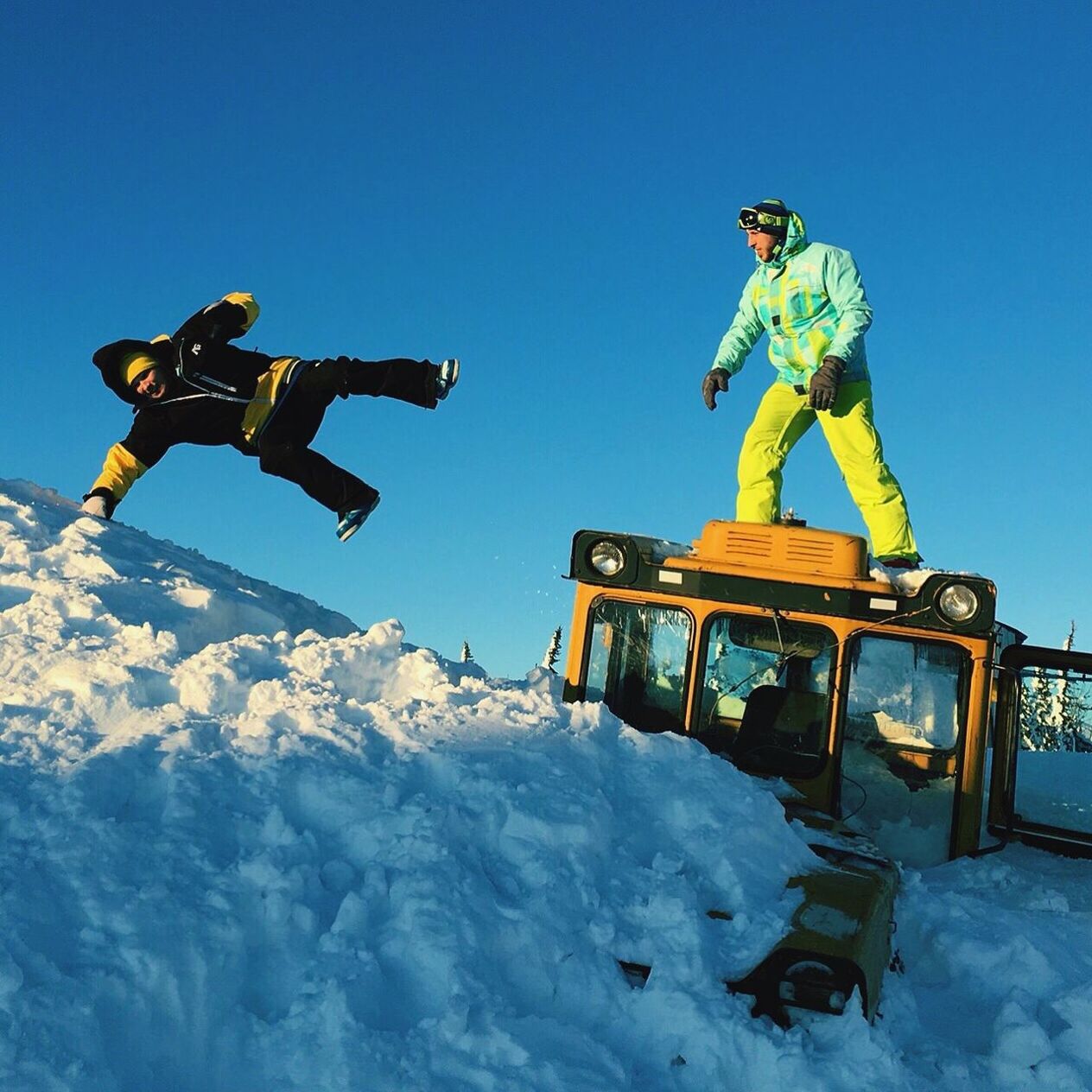 Low angle view of men enjoying in snow against sky
