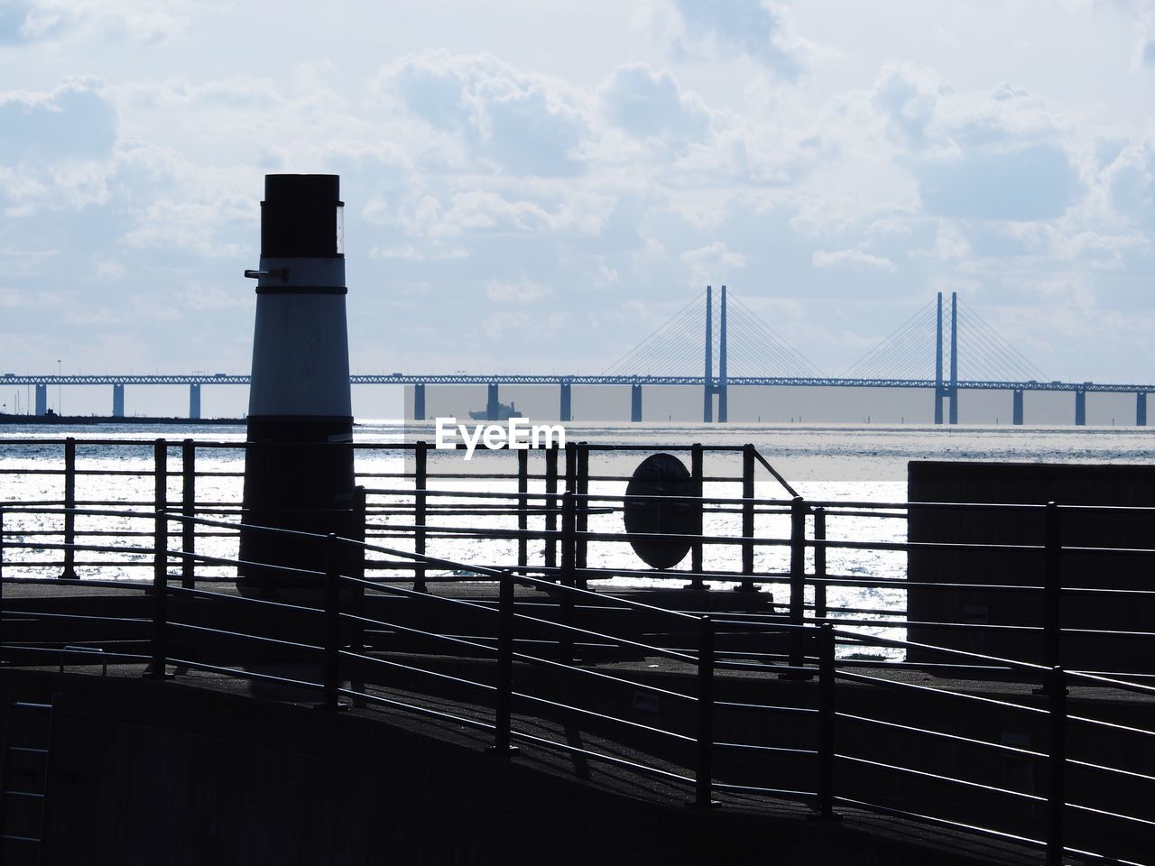 Suspension bridge over sea against sky