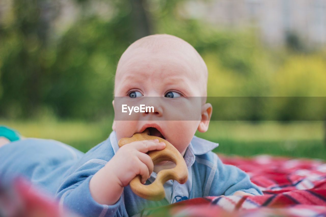 Close-up of cute boy eating toy