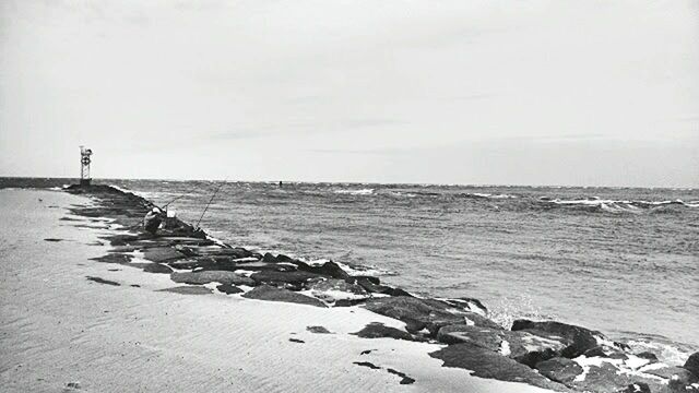 SCENIC VIEW OF SEA WITH ROCKS IN BACKGROUND